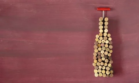 Flat lay of many wine corks and corkscew forming a wine bottle, wine treat Stock Photos