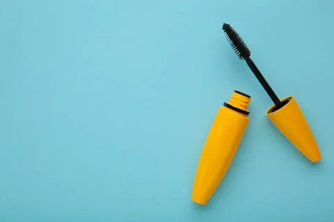 Flat lay mascara on blue background. Space for text Stock Photos