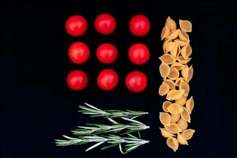 Flat lay meal on a black background, tomato and pasta 스톡 사진