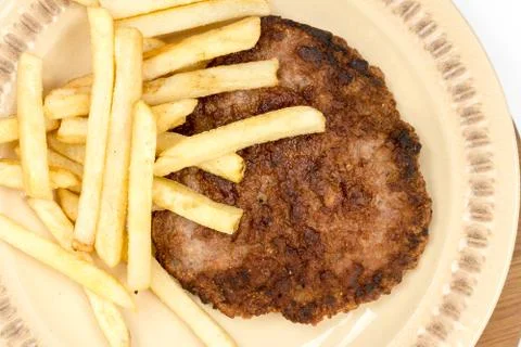 Flat lay minced meat hamburger with french fries on the plate Stock Photos