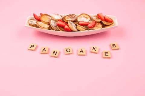 Flat lay minimal composition with mini pancakes cereal with strawberries on Stock Photos