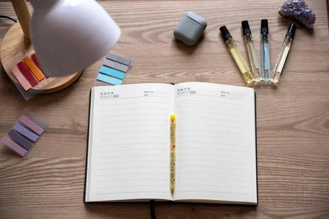 Flat lay of minimalist workspace featuring open blank diary. Stock Photos