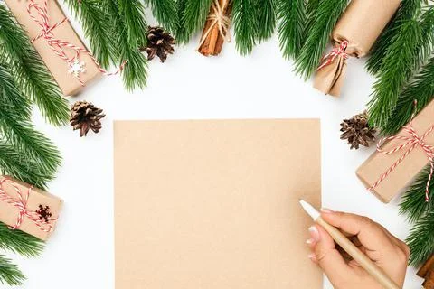 Flat lay, mock-up wish list and female hand writing checklist on table with Stock Photos