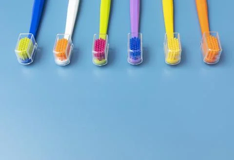 Flat Lay Multicolored Toothbrushes on Blue Background On Top. Oral Hygiene Stock Photos
