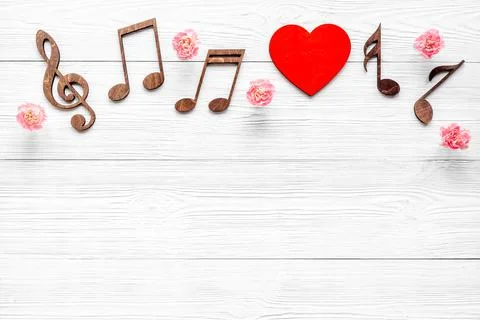 Flat lay of musical notes with flowers. Love songs concept Stock Photos