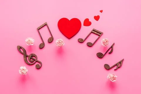 Flat lay of musical notes with flowers. Love songs concept Stock Photos