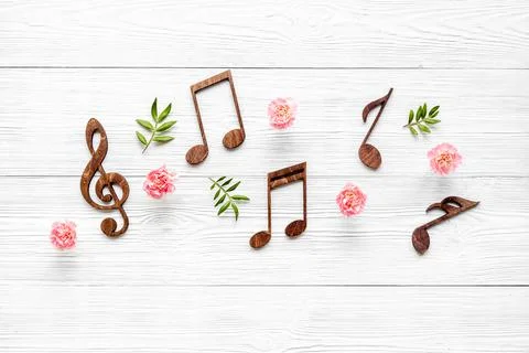Flat lay of musical notes with flowers. Love songs concept Stock Photos
