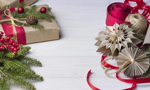 Flat lay with New Year, gift, red berries , ribbons. Craft paper for wrapping Фото