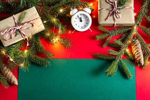 Flat lay new year or christmas greeting card clock, craft gifts and fir branc Stock Photos