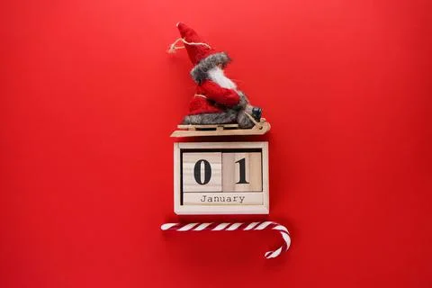 Flat lay New Year's composition. Old wooden calendar with Santa Claus on a sl Stock Photos