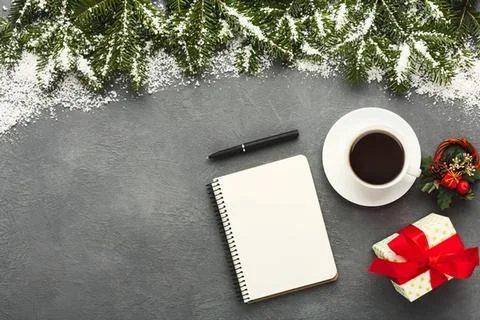 Flat lay of notebook coffee mug and gift box on table Stock Photos
