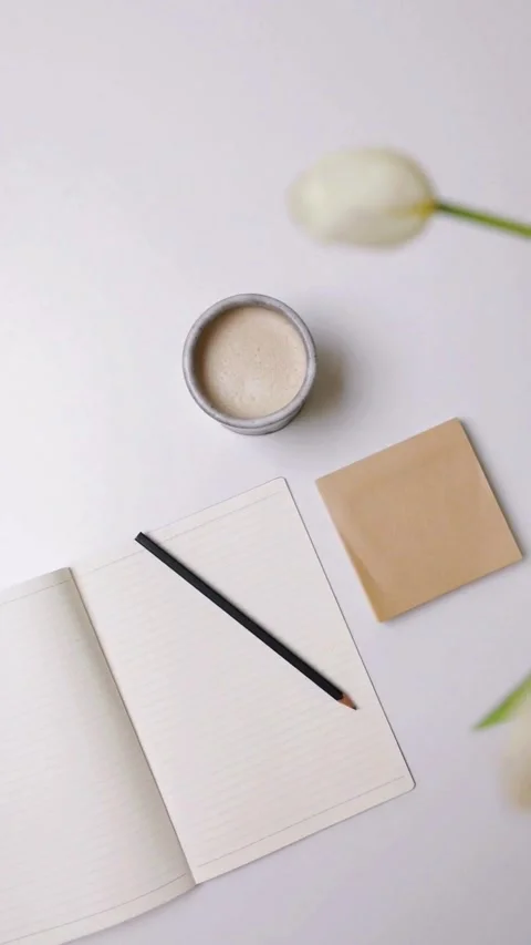 Flat Lay of Notebook, Pen, Makeup Powder, and Tulip on White Surface Video stock 343906735