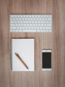 Flat lay of notebooks with brown pen on desktop. Stock Photos
