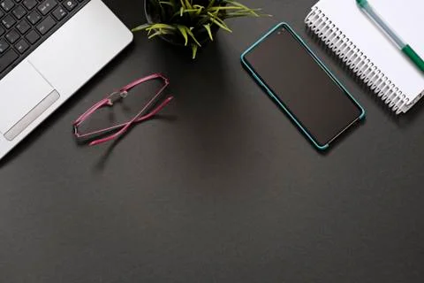 Flat lay with office supplies, computer and plant with copy space Stock Photos