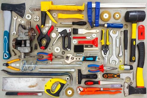 Flat lay of old and new hand tools on concrete background. Stock Photos