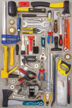 Flat lay of old and new hand tools on concrete background. Stock Photos