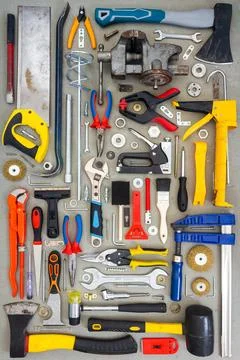 Flat lay of old and new hand tools on concrete background. Stock Photos