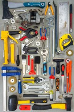 Flat lay of old and new hand tools on concrete background. Stock Photos