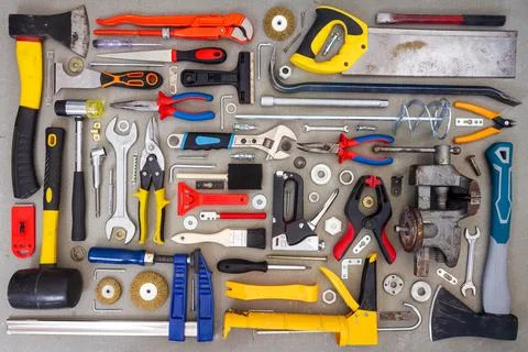 Flat lay of old and new hand tools on concrete background. Stock Photos