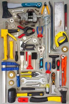 Flat lay of old and new hand tools on concrete background. Stock Photos
