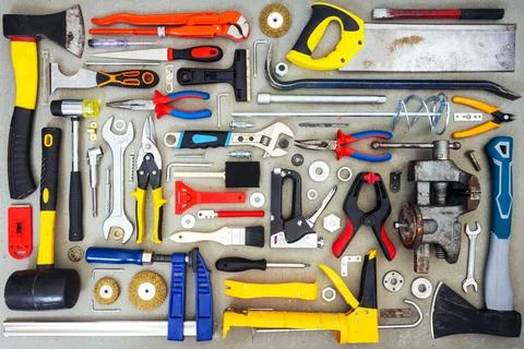 Flat lay of old and new hand tools on concrete background. Stock Photos