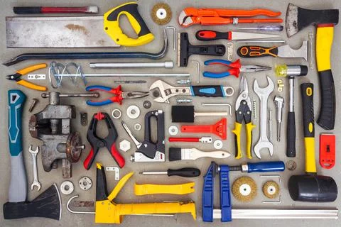 Flat lay of old and new hand tools on concrete background. Stock Photos