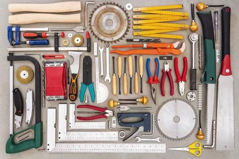 Flat lay of old hand tools on concrete background. Stock Photos