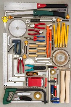 Flat lay of old hand tools on concrete background. Stock Photos
