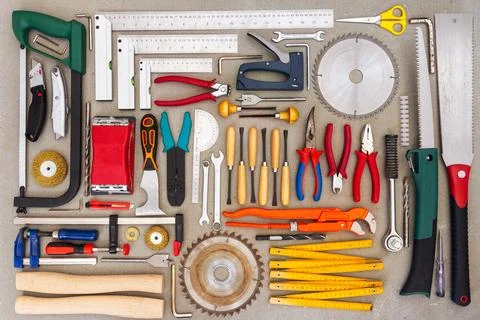 Flat lay of old hand tools on concrete background. Stock Photos