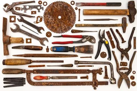Flat lay of old hand tools on white background. Stock Photos