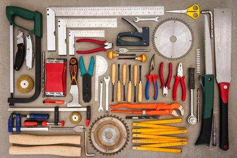 Flat lay of old hand tools on concrete background. Stock Photos