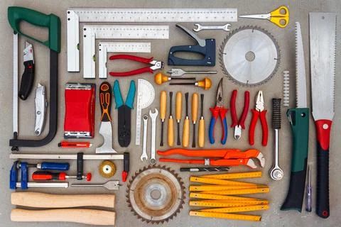 Flat lay of old hand tools on concrete background. Stock Photos