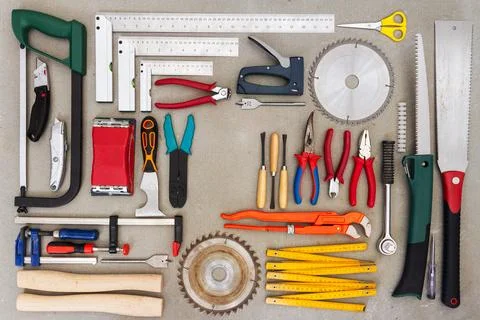 Flat lay of old hand tools on concrete background. Stock Photos