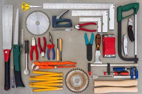 Flat lay of old hand tools on concrete background. Stock Photos