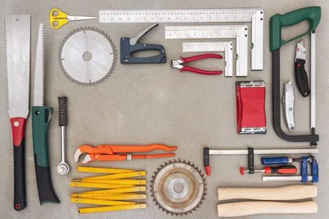 Flat lay of old hand tools on concrete background. Stock Photos