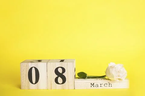Flat lay ?omposition March 8 wooden calendar with flower on a yellow backgrou Stock Photos
