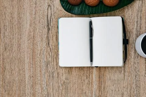 Flat lay, open blank U-turn of a notepad, white paper, morning recording Stock Photos
