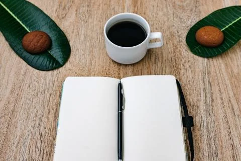 Flat lay, open blank U-turn of a notepad with white paper, morning recording Stock Photos