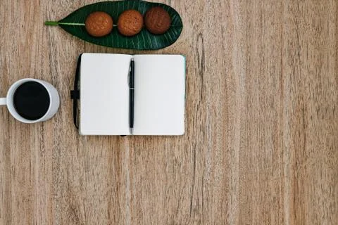 Flat lay, open blank U-turn of a notepad with white paper, morning recording Stock Photos