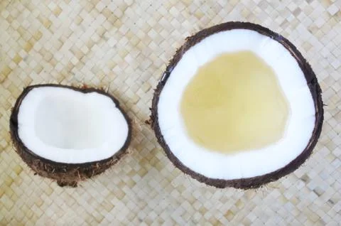 Flat lay of open coconut palm fruit with coconut oil in it Stock Photos