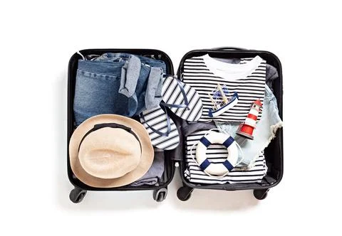 Flat lay with open suitcase with casual clothes for summer vacations over w.. Fotos Stock