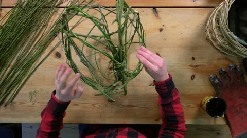 Flat Lay Open Weave Egg Shaped Basket Being Made With Wooden Desk Background Video stock 253337488