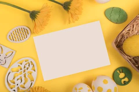 Flat lay with painted easter eggs, gerbera and easter decorations on yellow Stock Photos