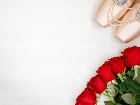 Flat lay pair of pink Pointe Shoes, pearl beads, red roses on white backgroun Stock Photos