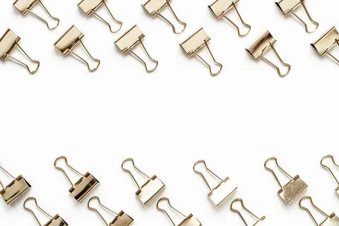 Flat lay of paper binder clips, office supplies pattern Stock Photos
