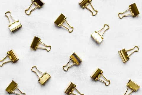 Flat lay of paper binder clips, office supplies pattern Stock Photos