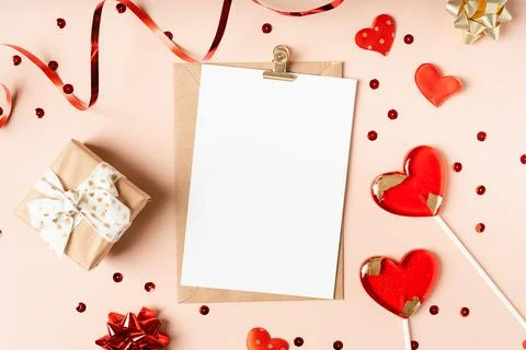 Flat lay of paper envelope with blank mockup greeting paper card. Pink table Stock Photos