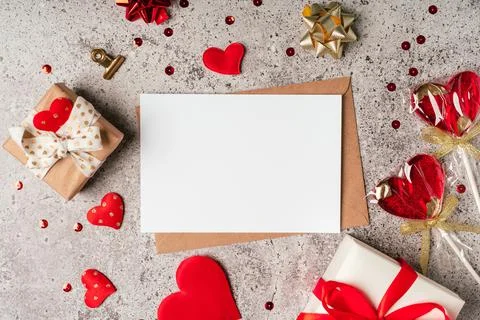 Flat lay of paper envelope with blank mockup greeting card. Grey table Stock Photos