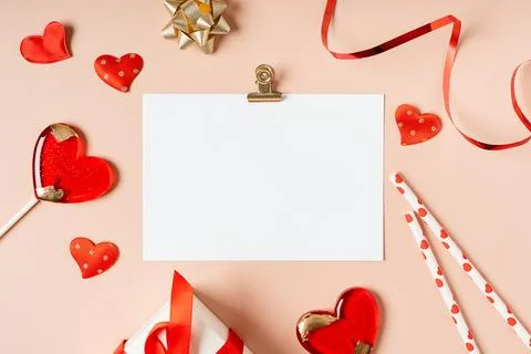 Flat lay of paper envelope with blank mockup greeting paper card. Pink table Stock Photos