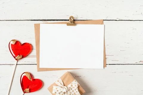 Flat lay of paper envelope with blank mockup greeting paper card. White wooden Stock Photos